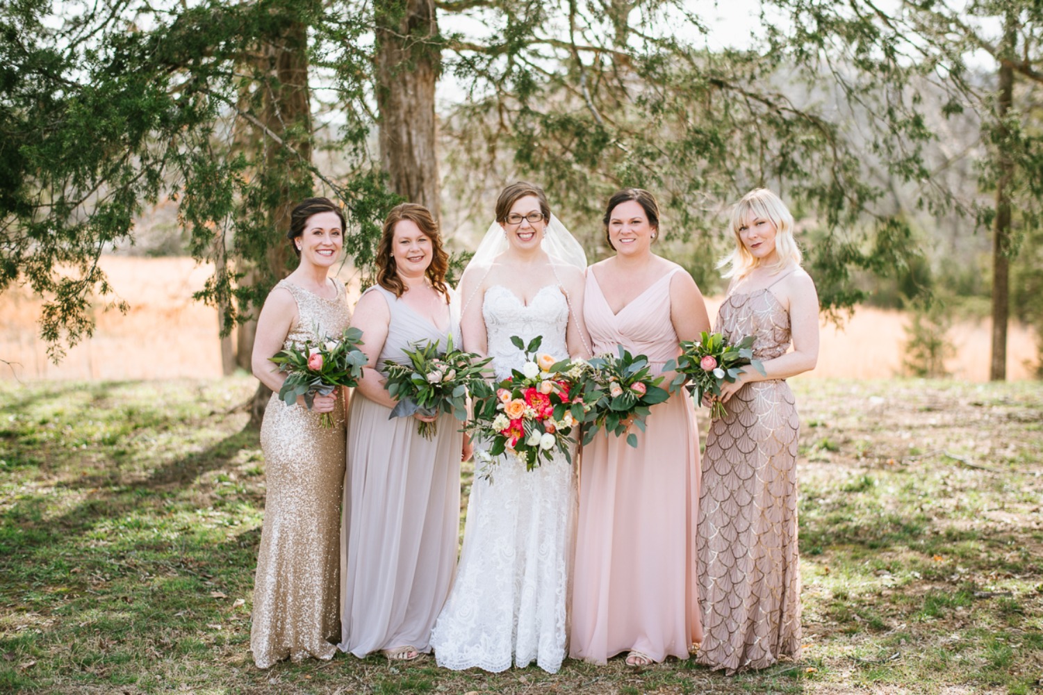 mismatched bridesmaids dressing in blush and gold