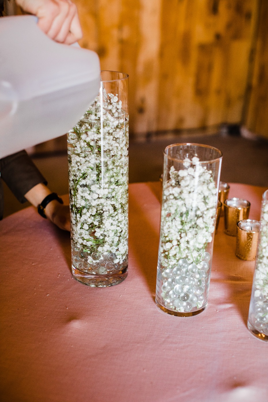 DIY Wedding Reception Centerpiece Pouring in Water to Float Flowers