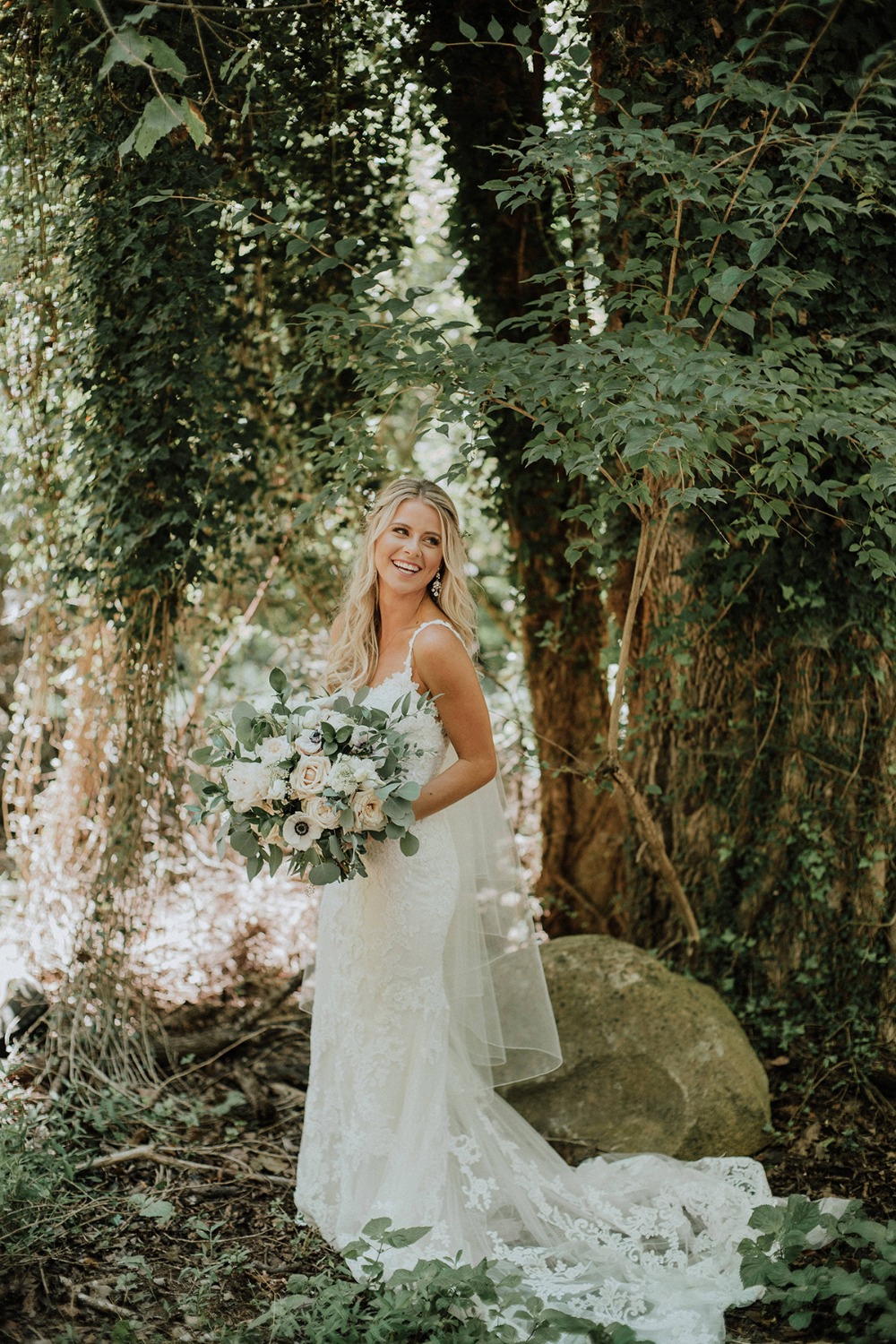 bride in fit and flair lace gown from Posh Bridal