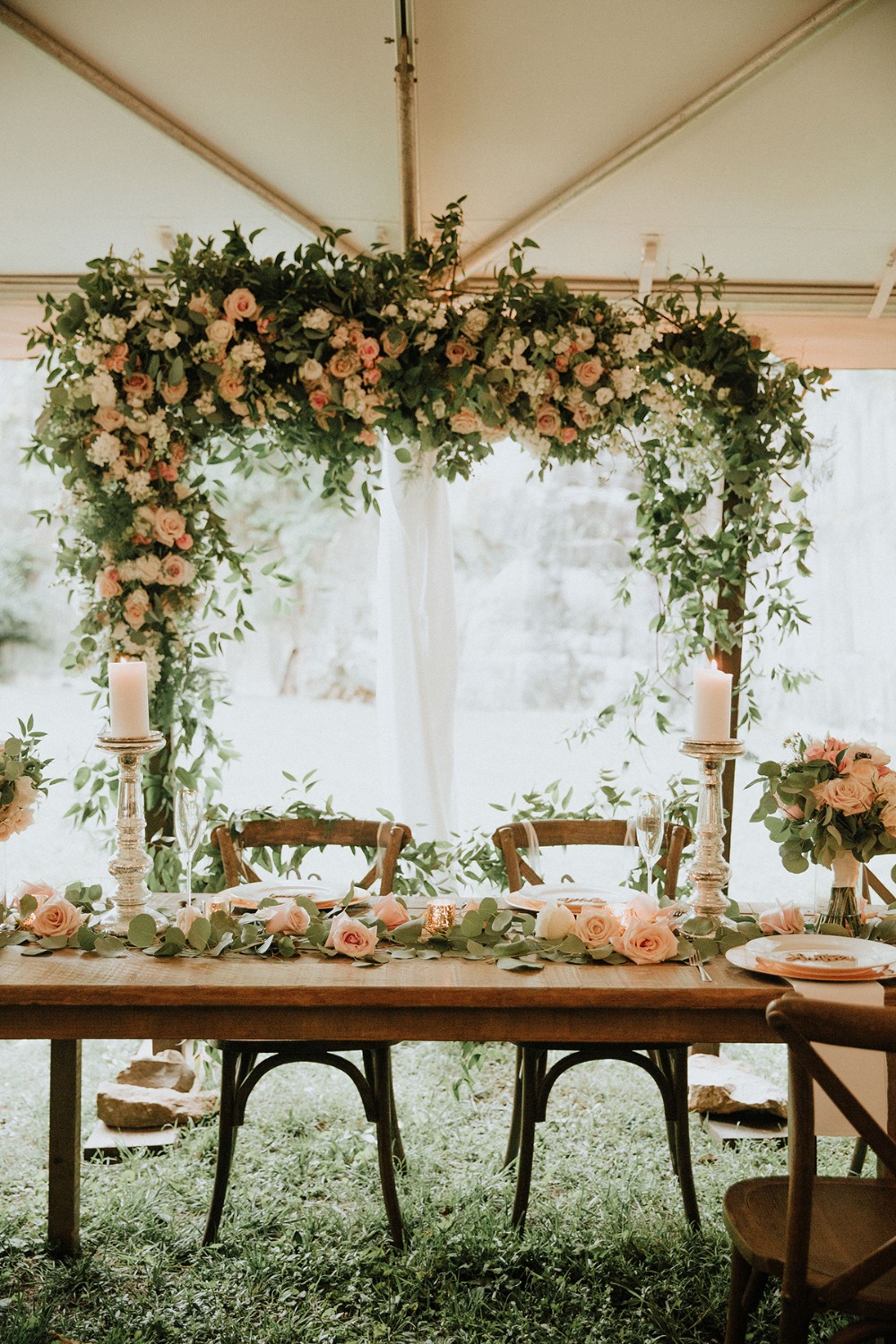 wedding arch behind the sweetheart table