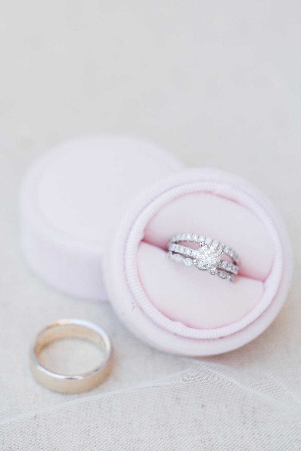 soft pink ring box and wedding rings