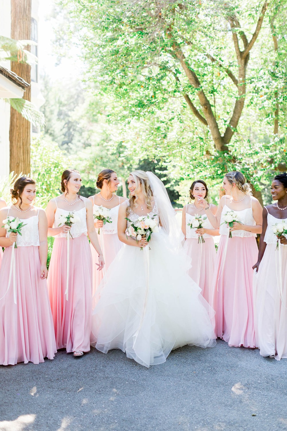 pink skirts and white cropped top bridesmaids