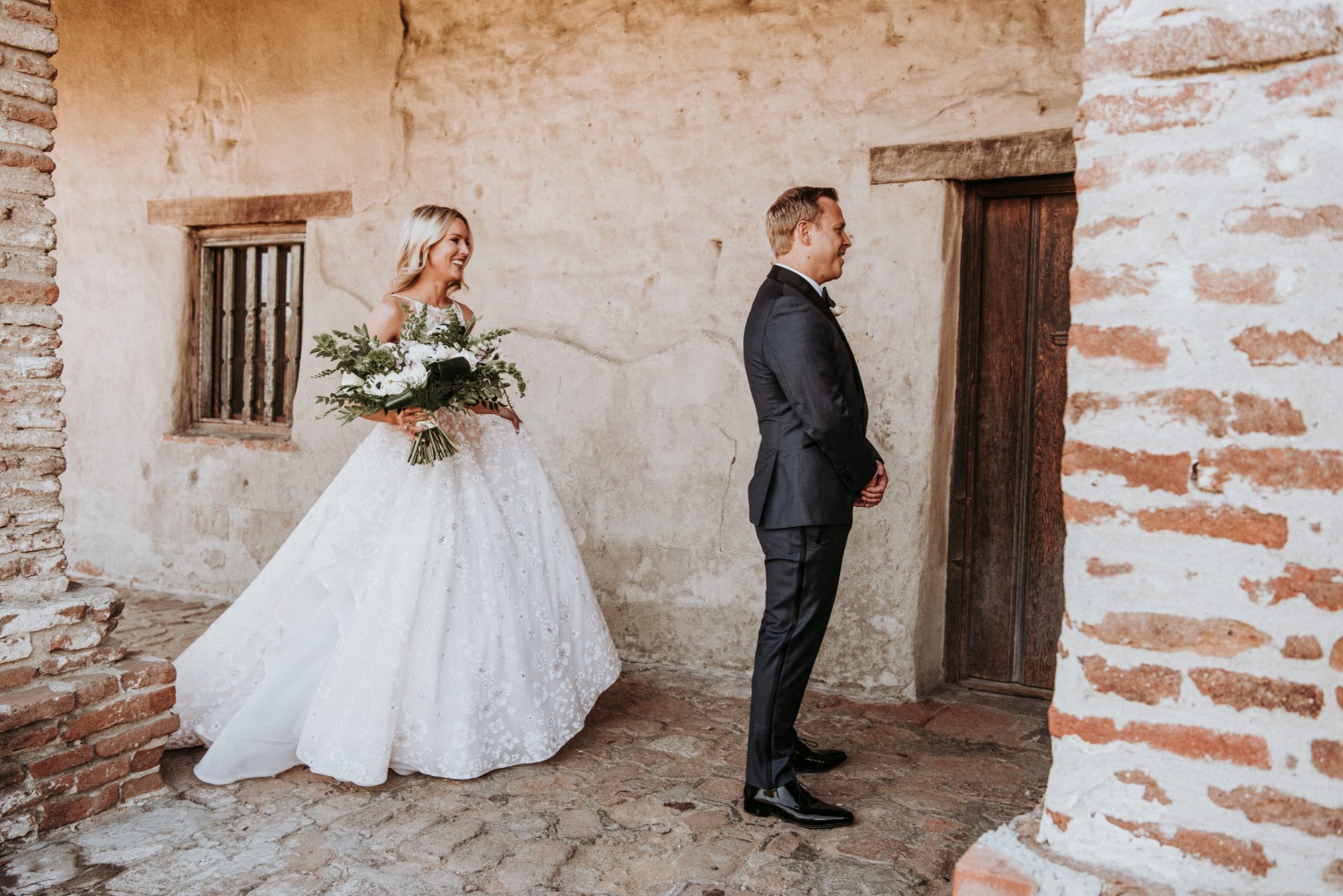 Bride walking to the groom before wedding day first look ceremony