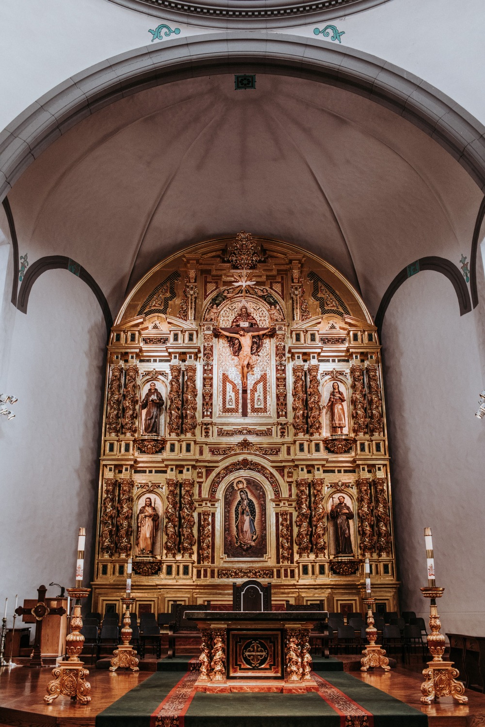 Ornate golden altar with crucifix in a church interior