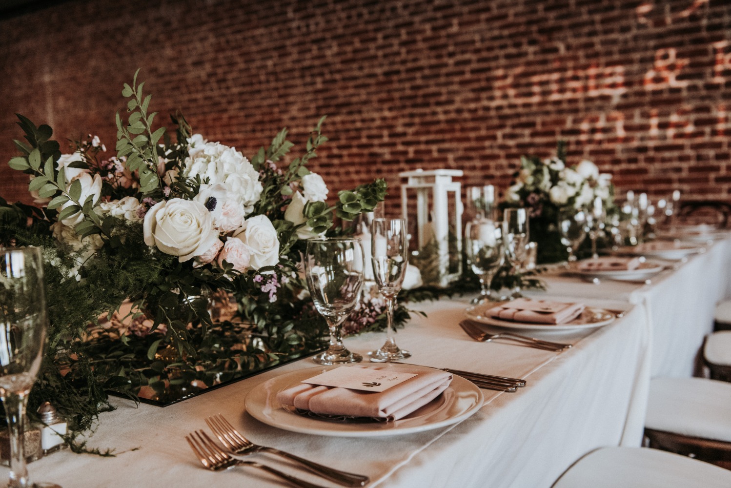 Wedding table setting with floral arrangement roses