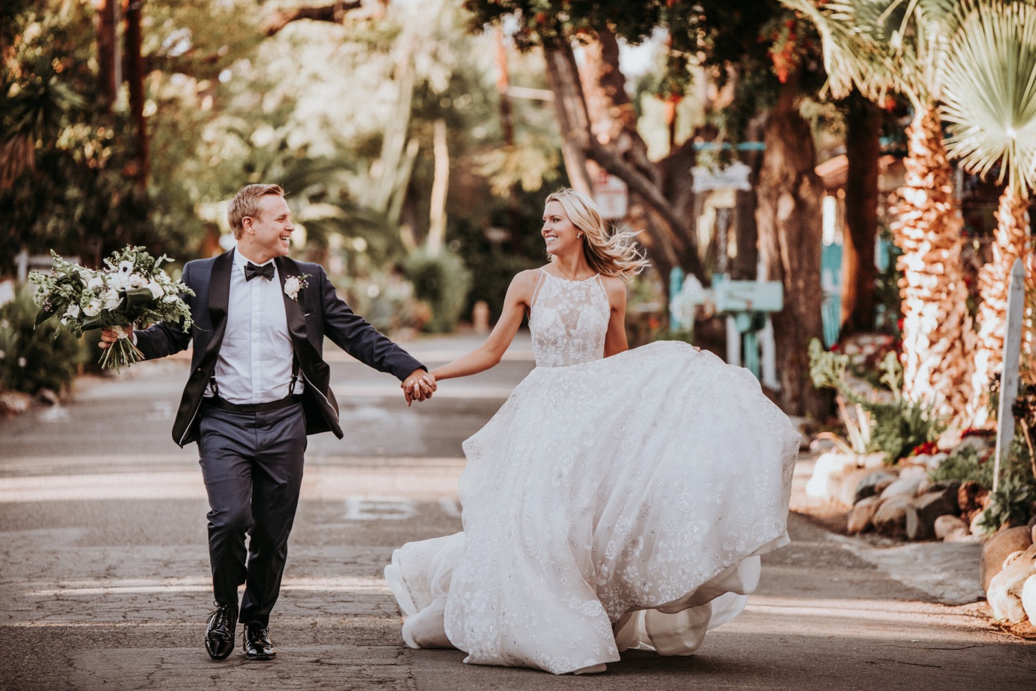 Newlyweds joyfully running hand in hand after their wedding
