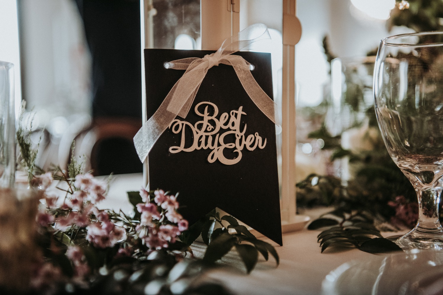 Elegant wedding table decor with best day ever sign and flowers