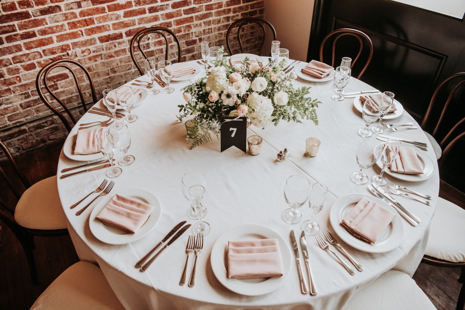 Elegant wedding reception table with floral centerpiece