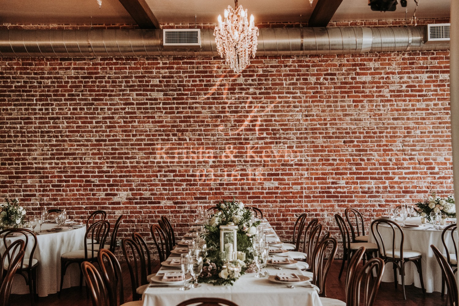 Wedding reception venue with brick wall and elegant tables