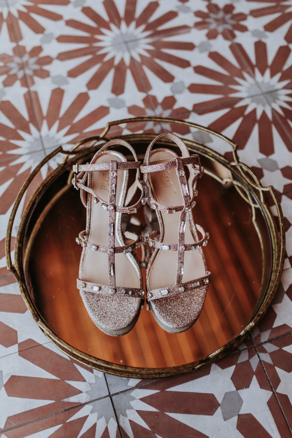 Sparkling bridal shoes on a mirrored tray, wedding day details