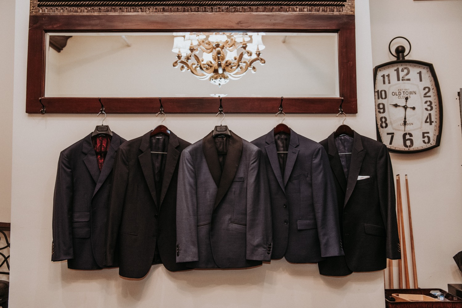 Four suits hanging neatly, ready for a special occasion