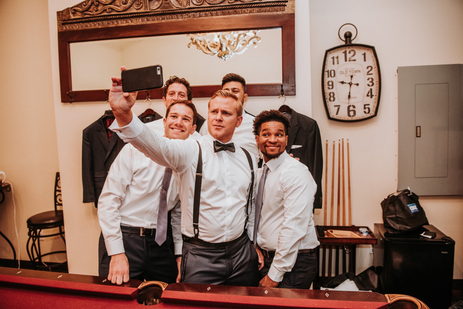 Groomsmen taking a selfie before the wedding ceremony