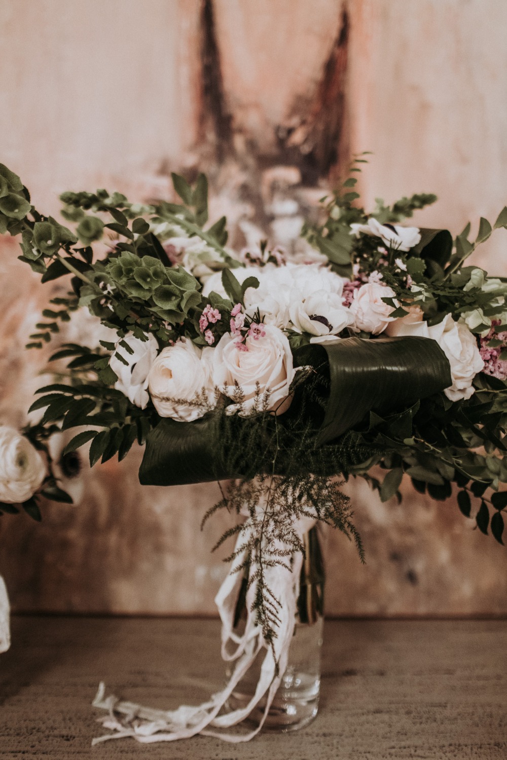 Elegant bouquet of roses and greenery in glass vase