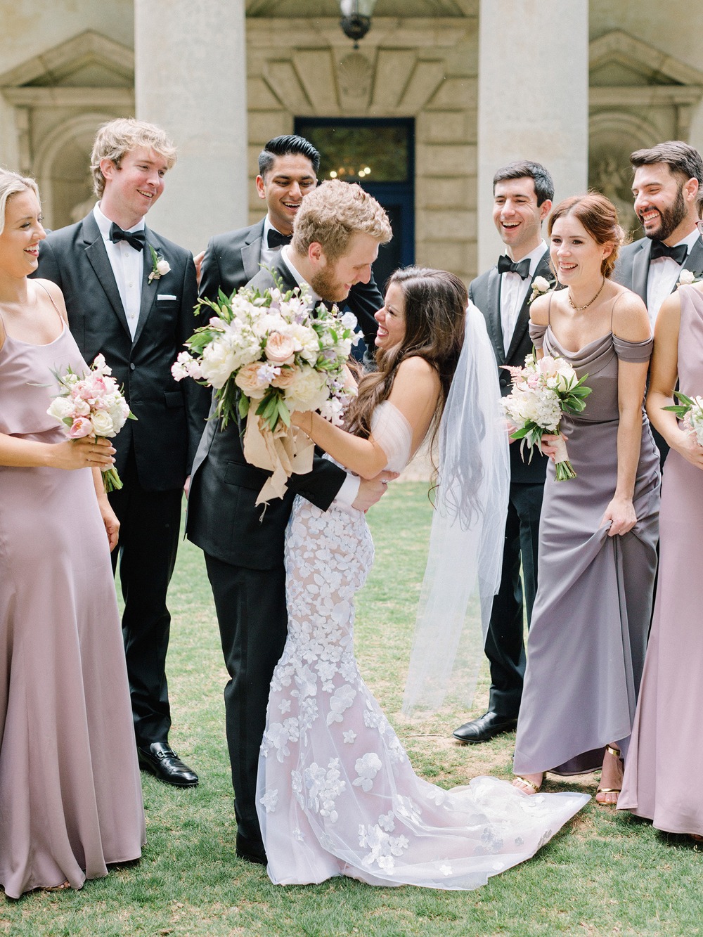 Happy bride and groom surrounded by wedding party
