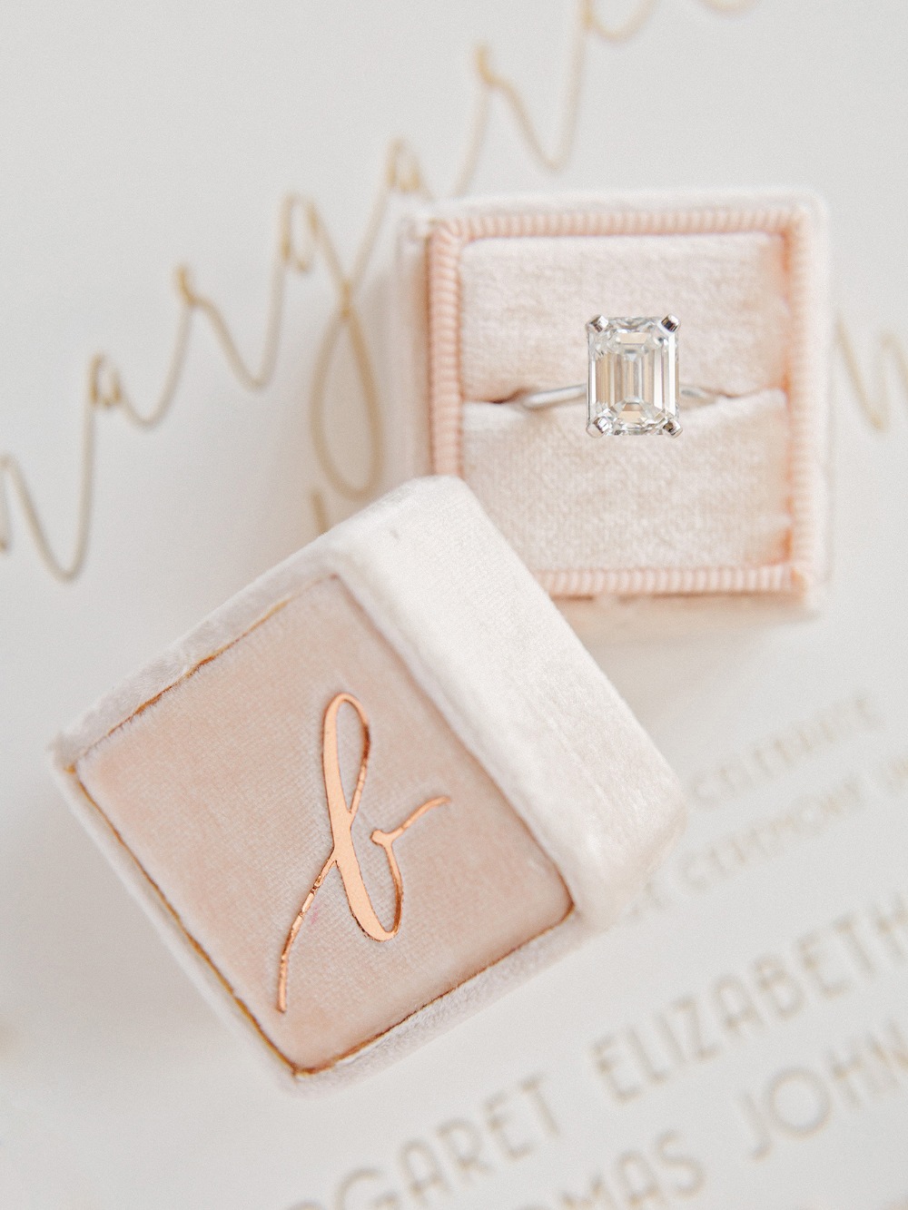 Emerald cut diamond ring in pink velvet box with initial