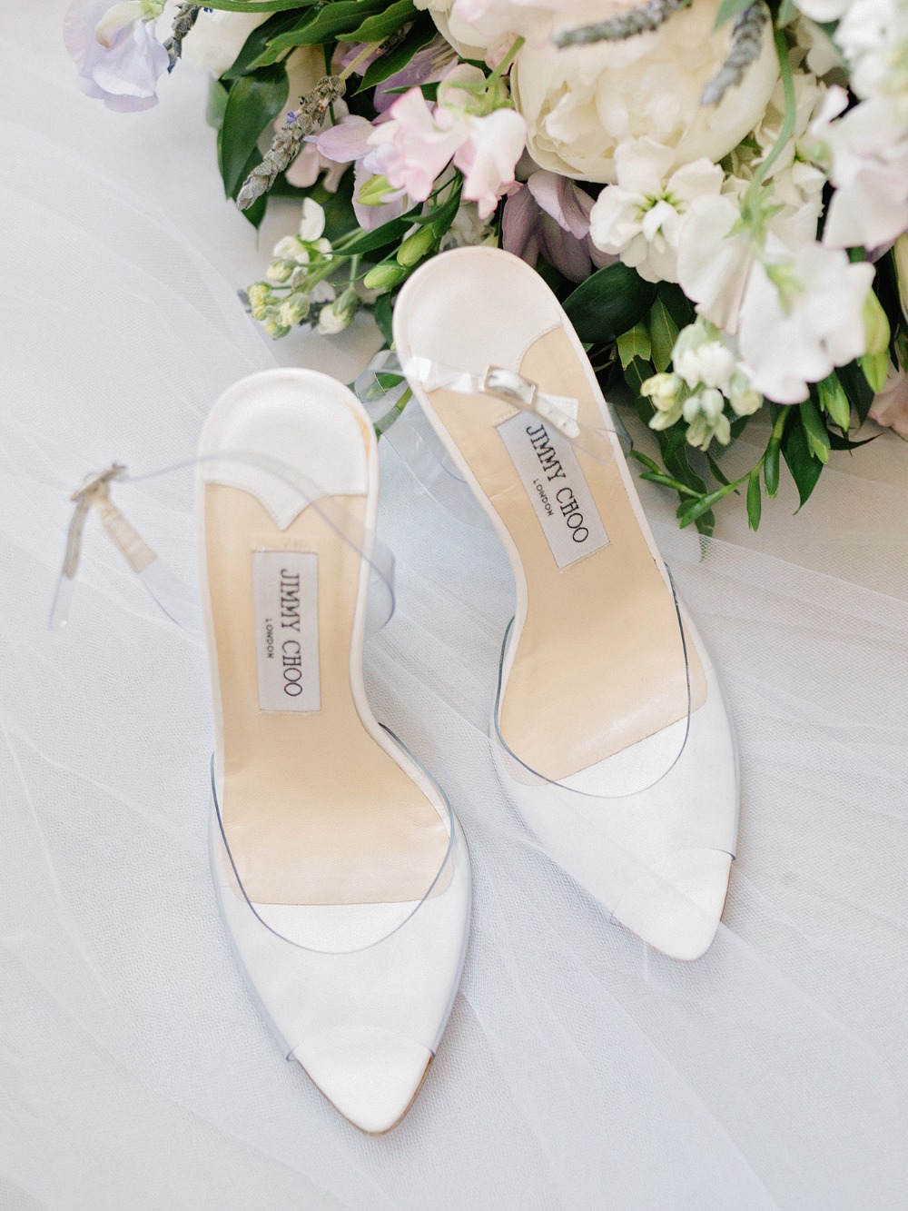 Jimmy Choo wedding shoes with white flowers bouquet