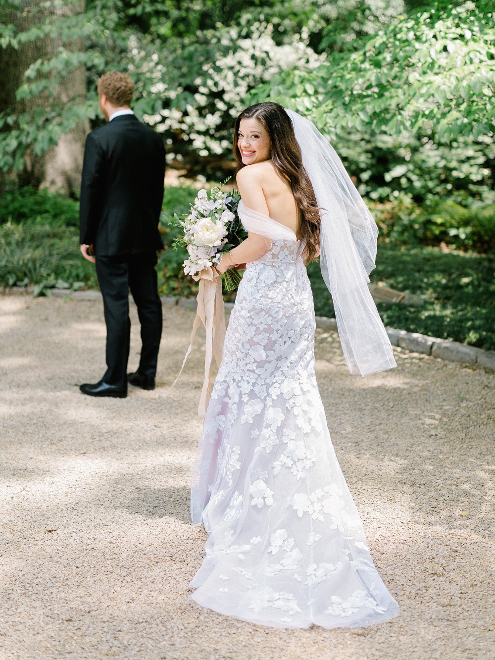 Bride turning to smile at groom before wedding ceremony
