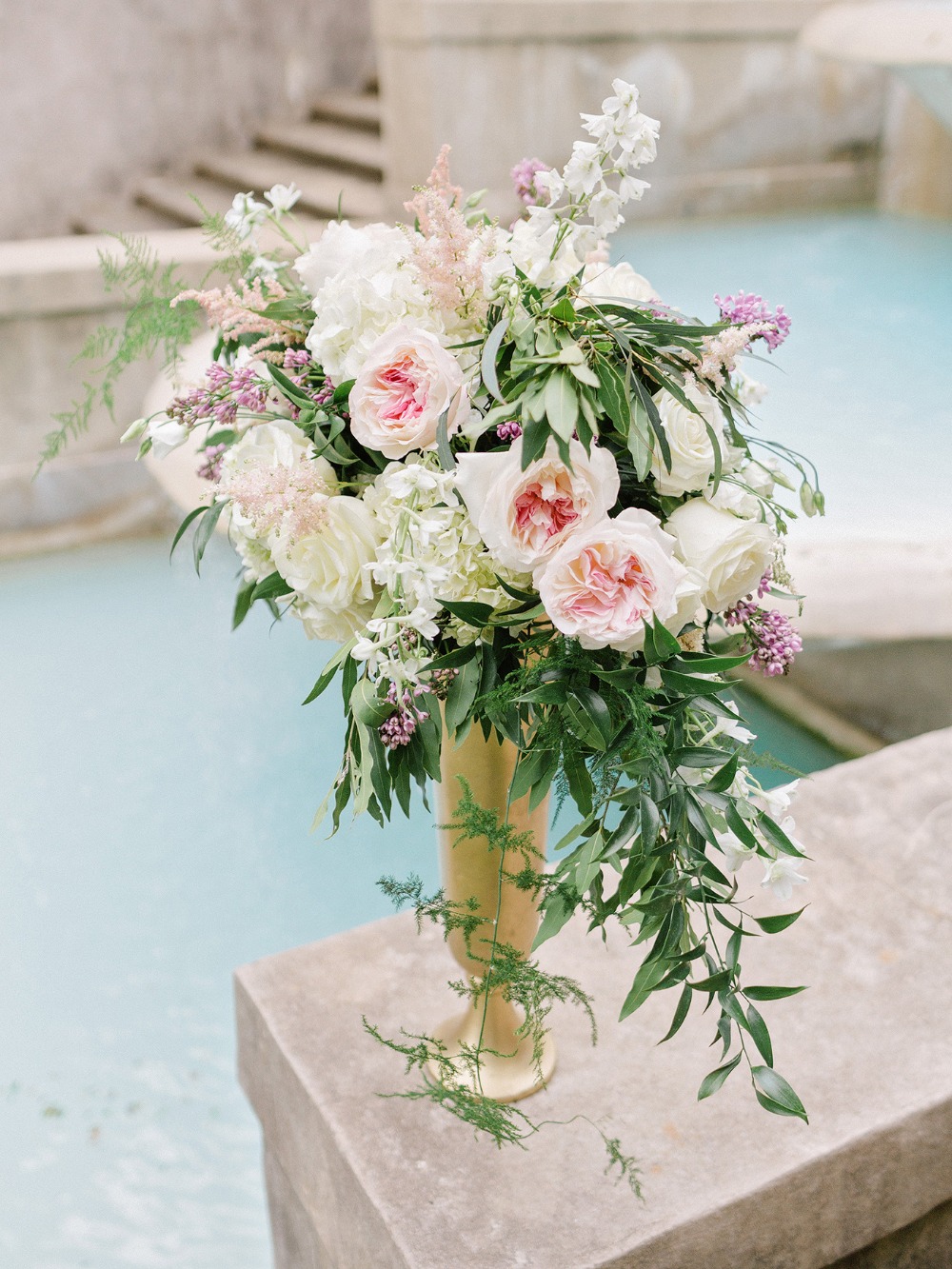 Elegant pink and white floral arrangement in gold vase