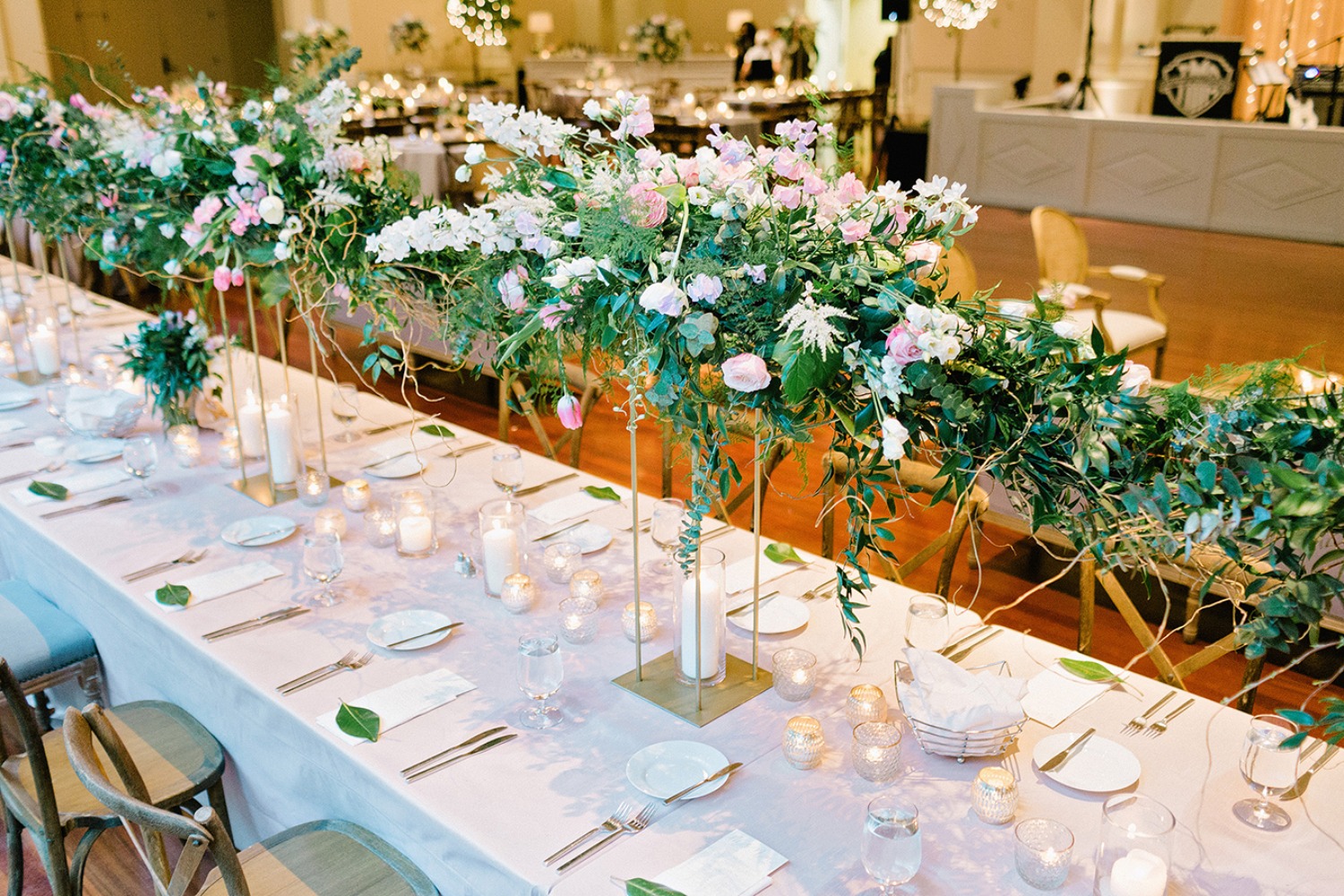 Wedding reception table setting with lush floral decor