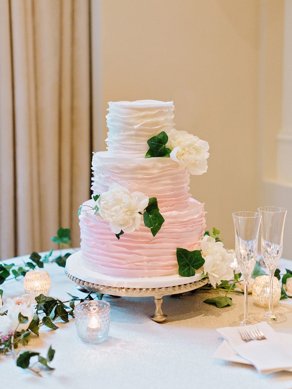 Elegant three tier wedding cake with floral decorations