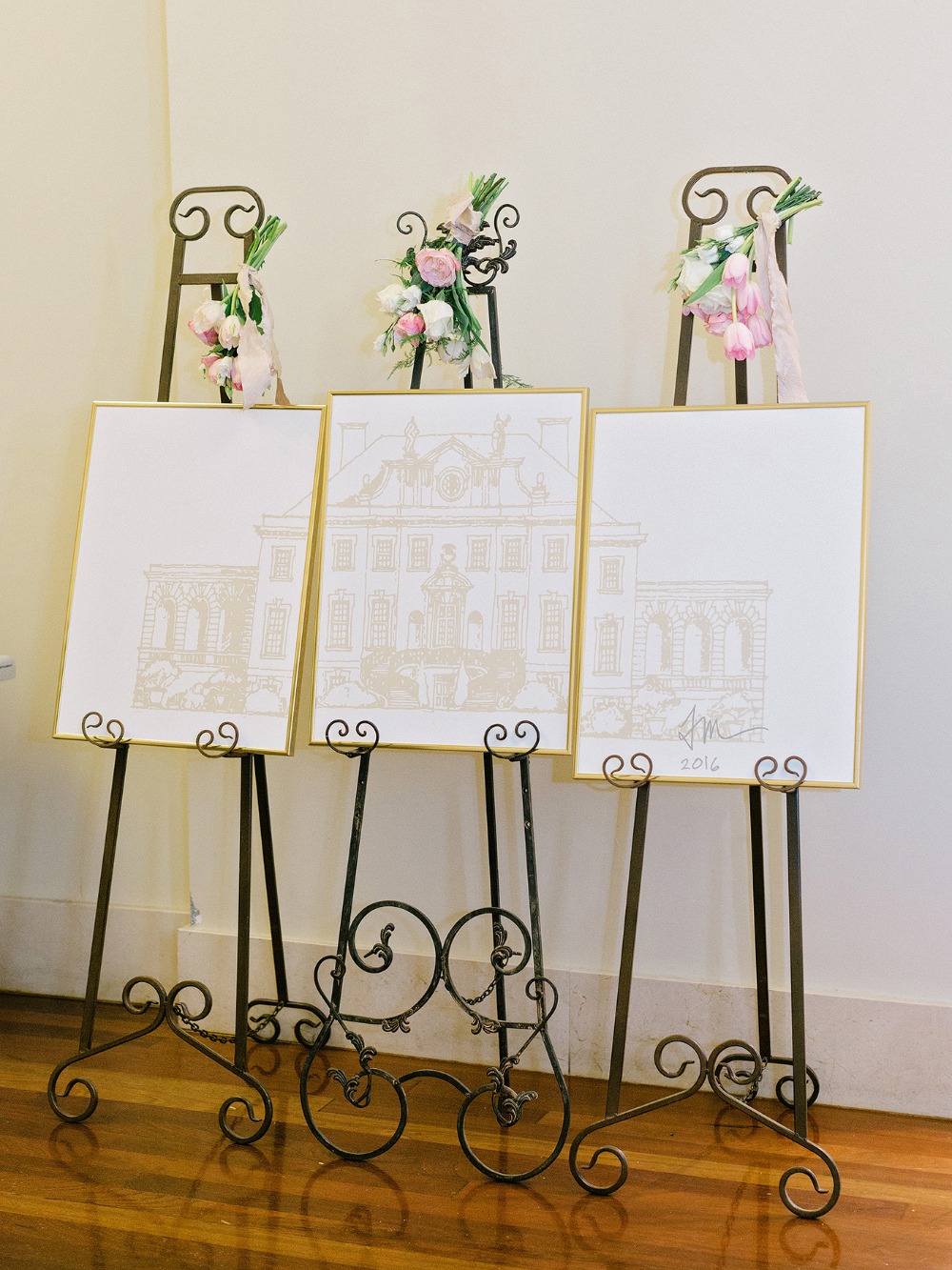 Wedding reception art on easels with floral decor