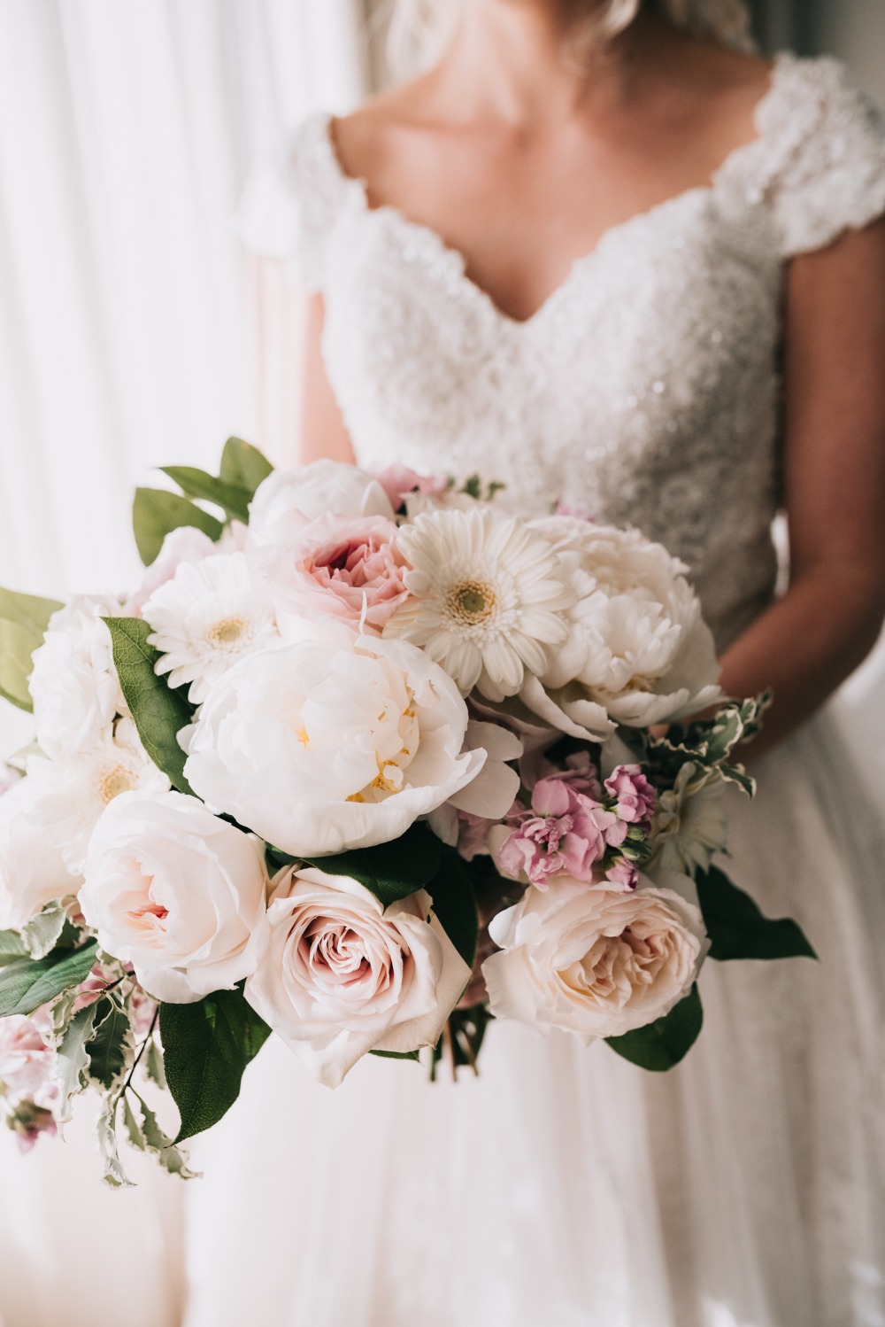 white wedding bouquet with a touch of pink