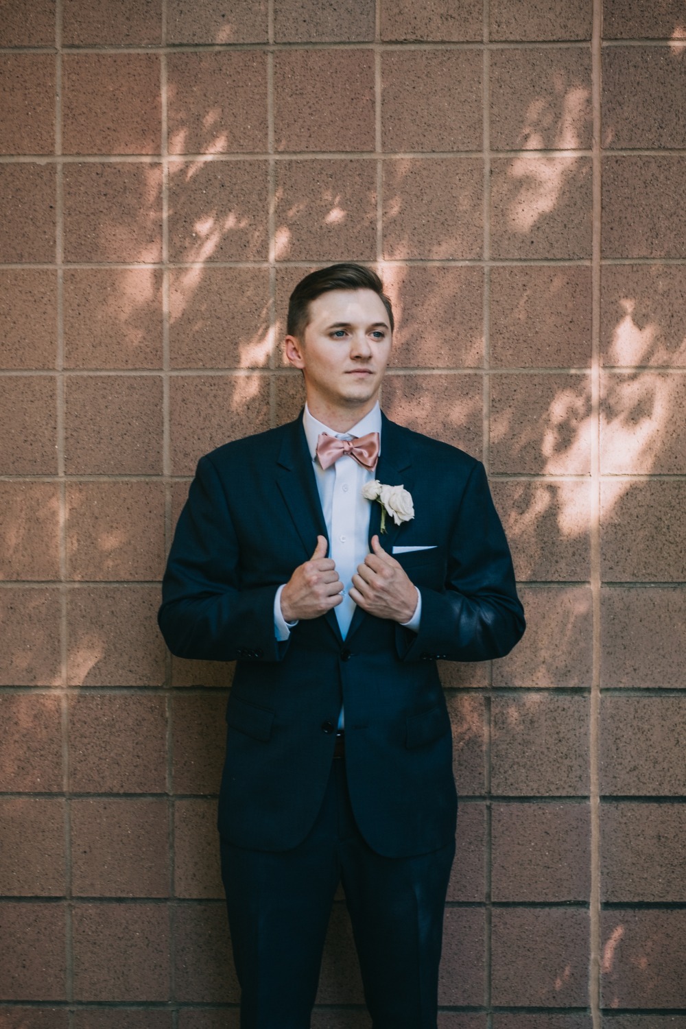 groom in navy and pink