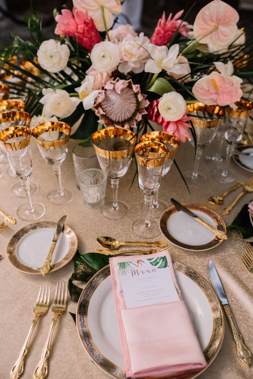 pink and gold wedding table with tropical accents