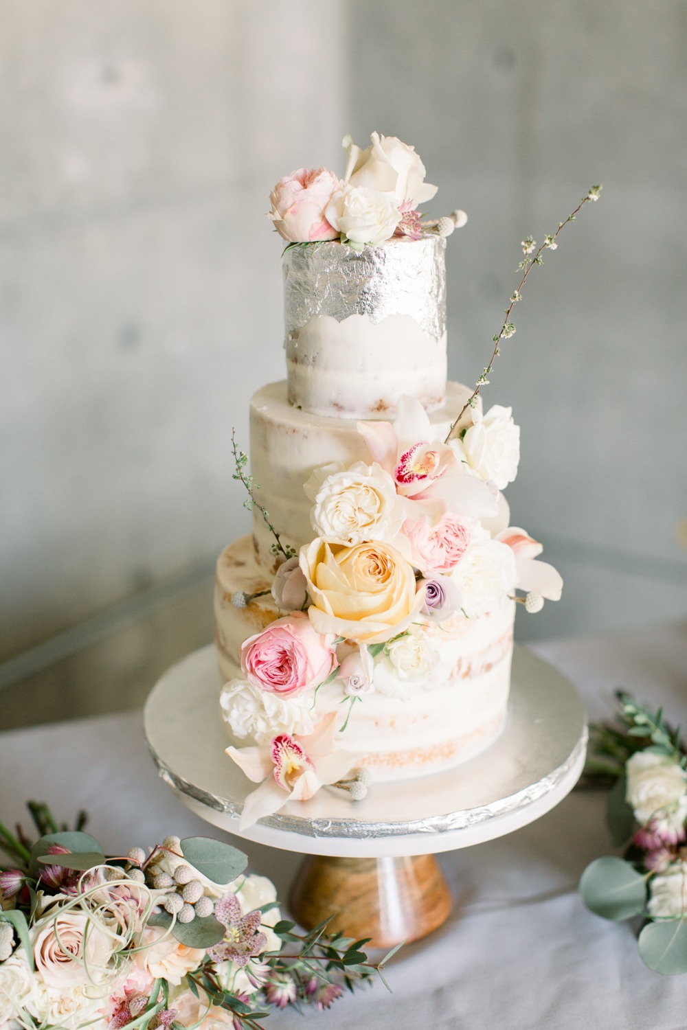 Naked metallic wedding cake with florals