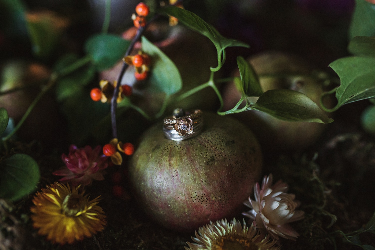 wedding rings on a pomegranate