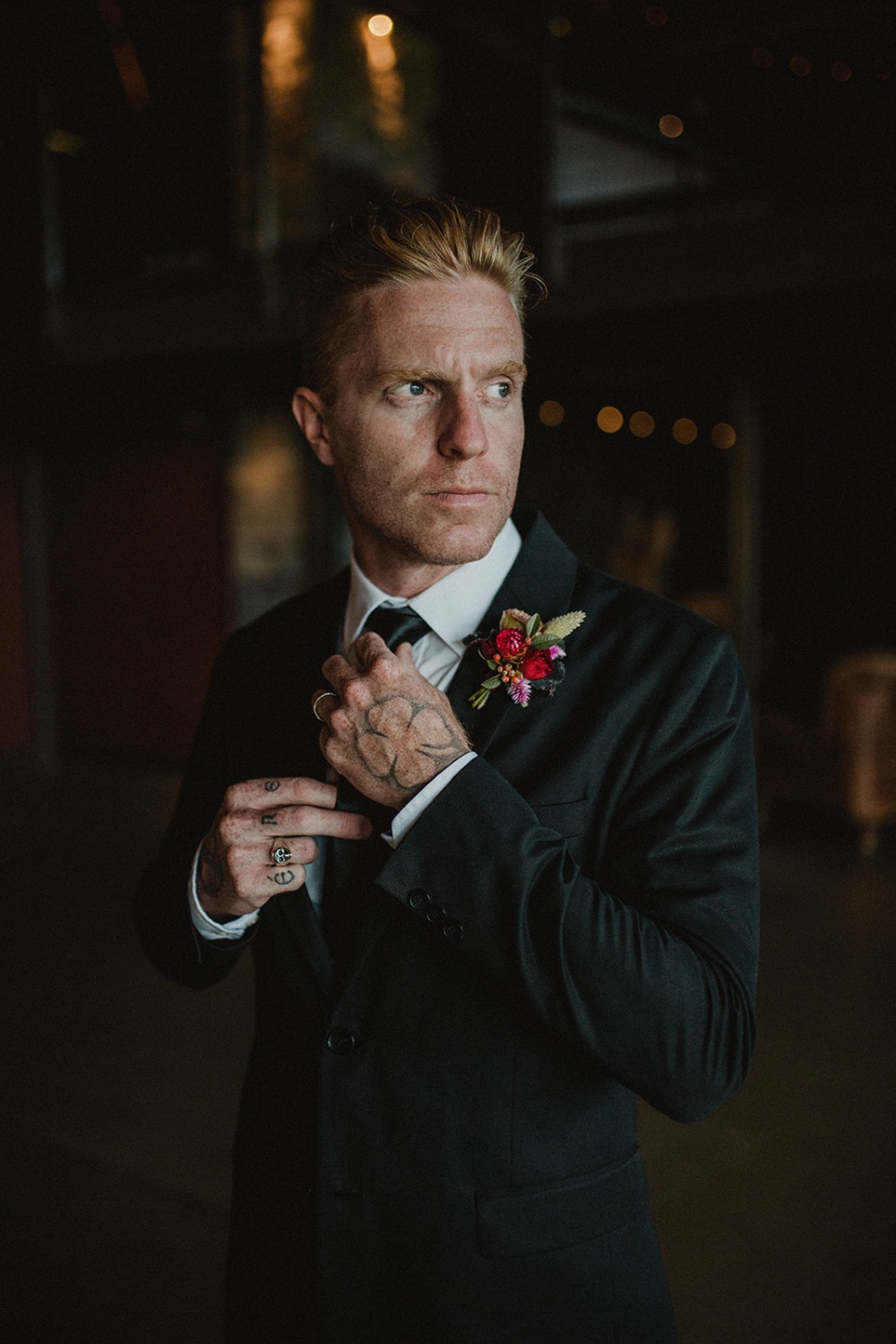 groom in sleek black suit