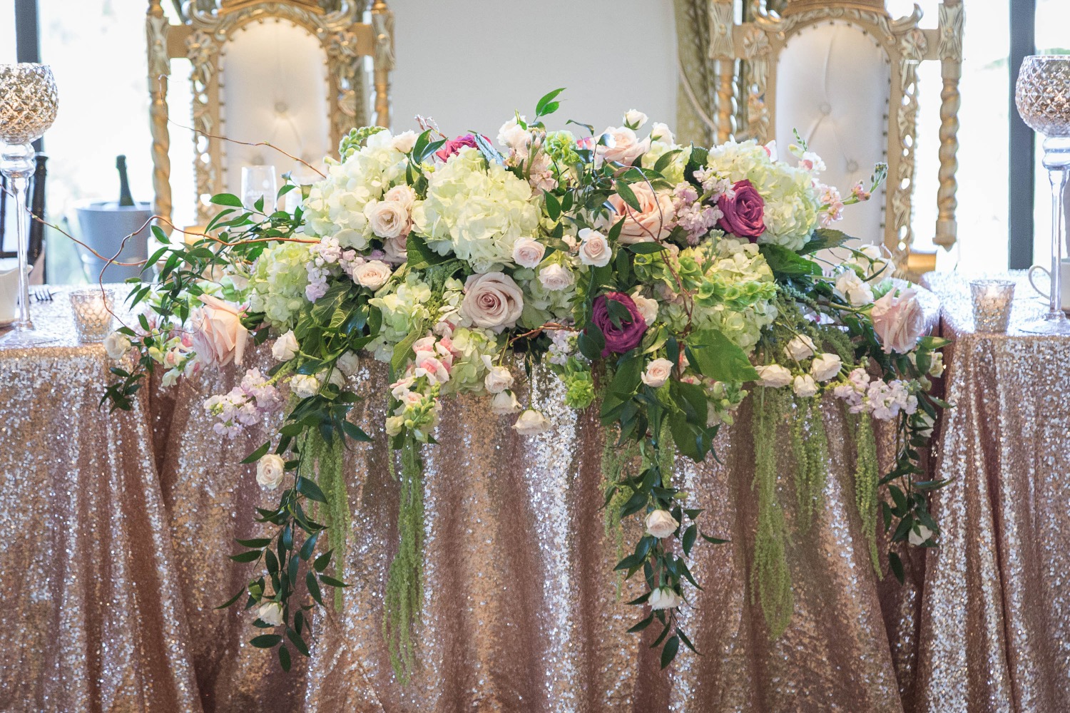 chic sequin table linen with cascading floral centerpiece