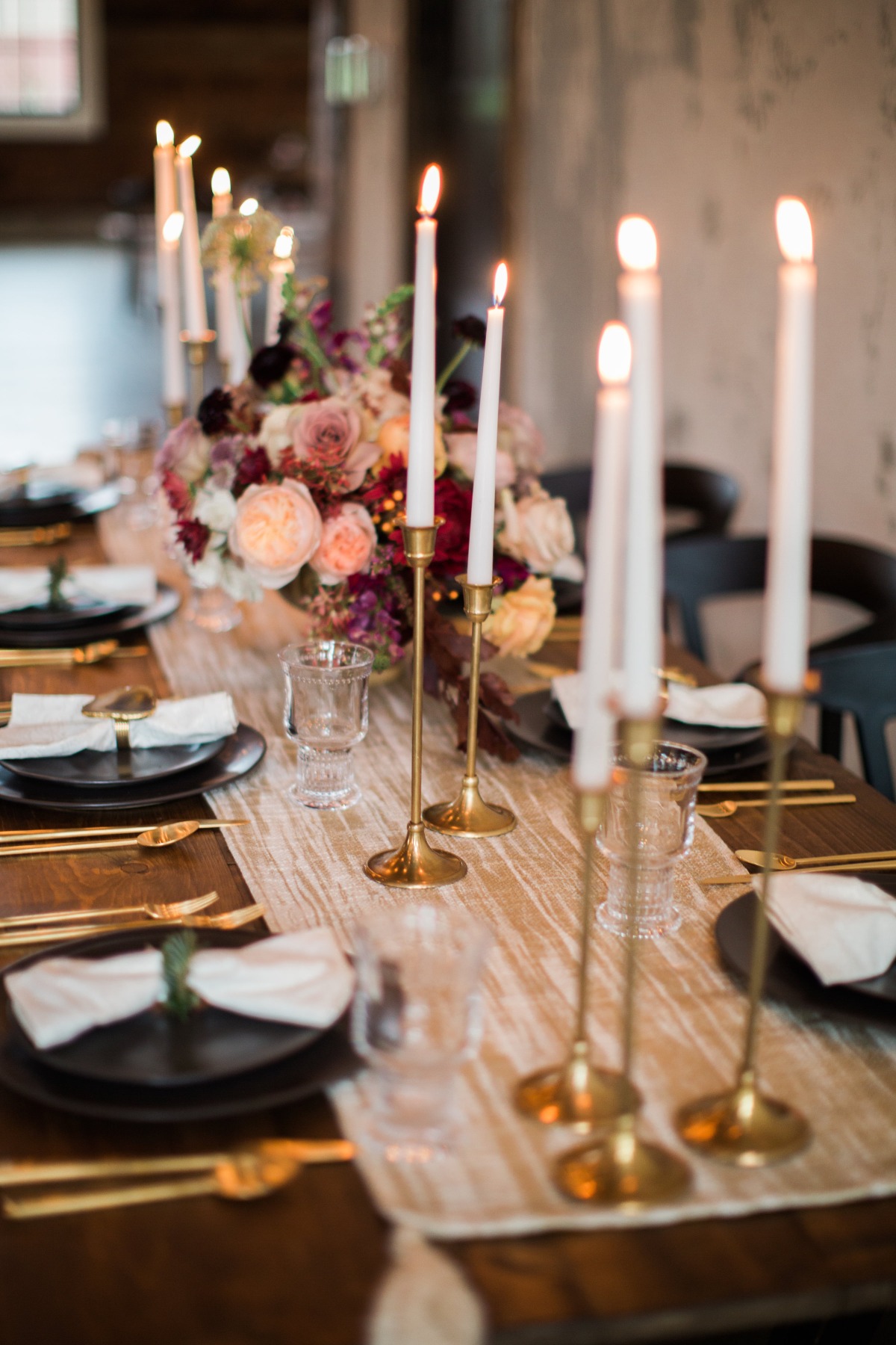 Elegant table setting with candles, flowers, and gold accents