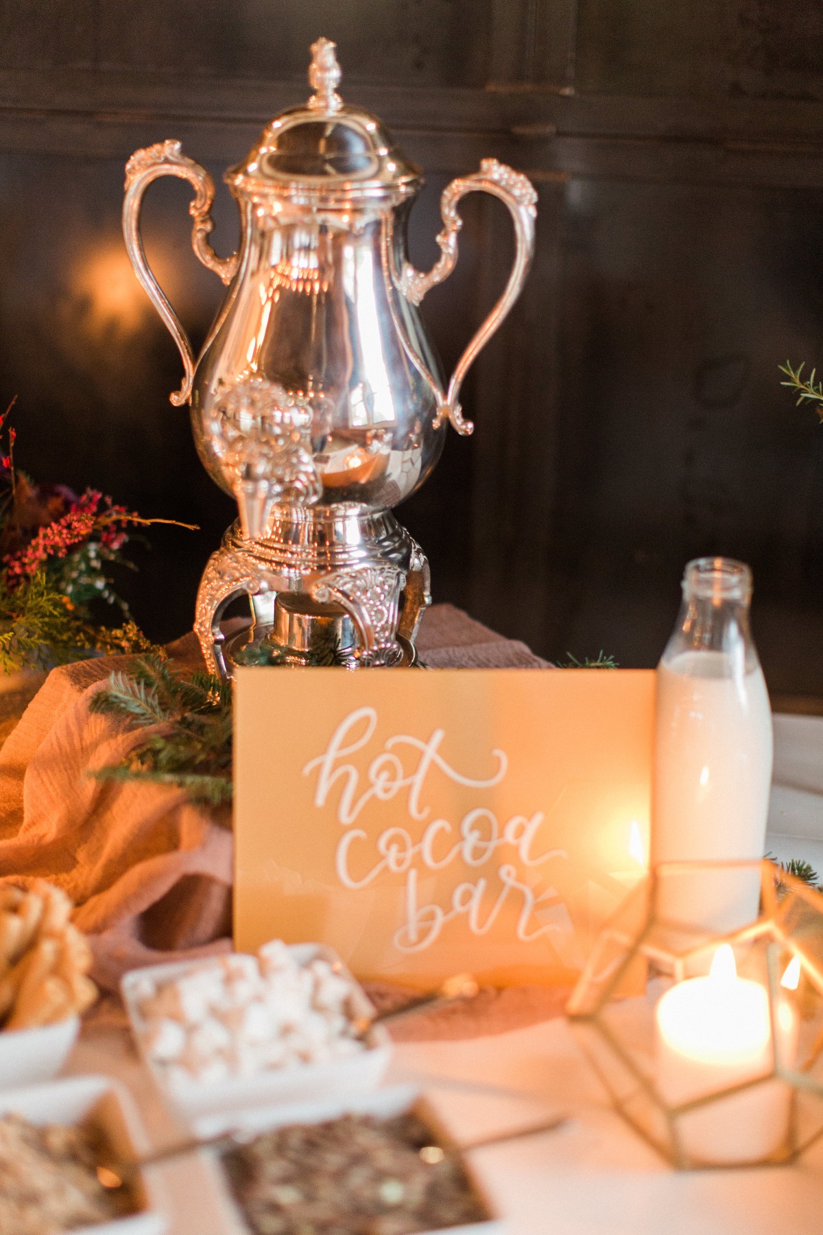 Elegant hot cocoa bar setup with silver urn and toppings