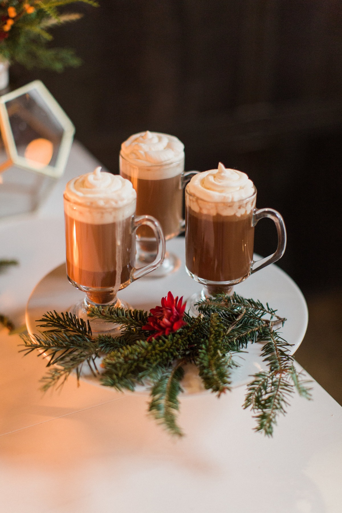 Three glasses of hot chocolate topped with whipped cream