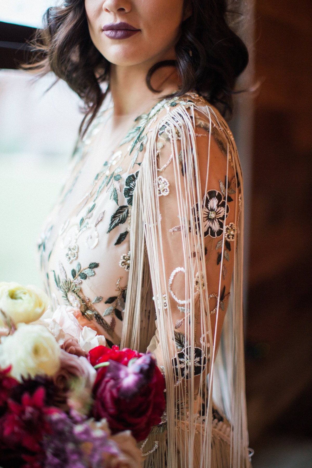 Elegant bride in floral embroidered dress and fringe details