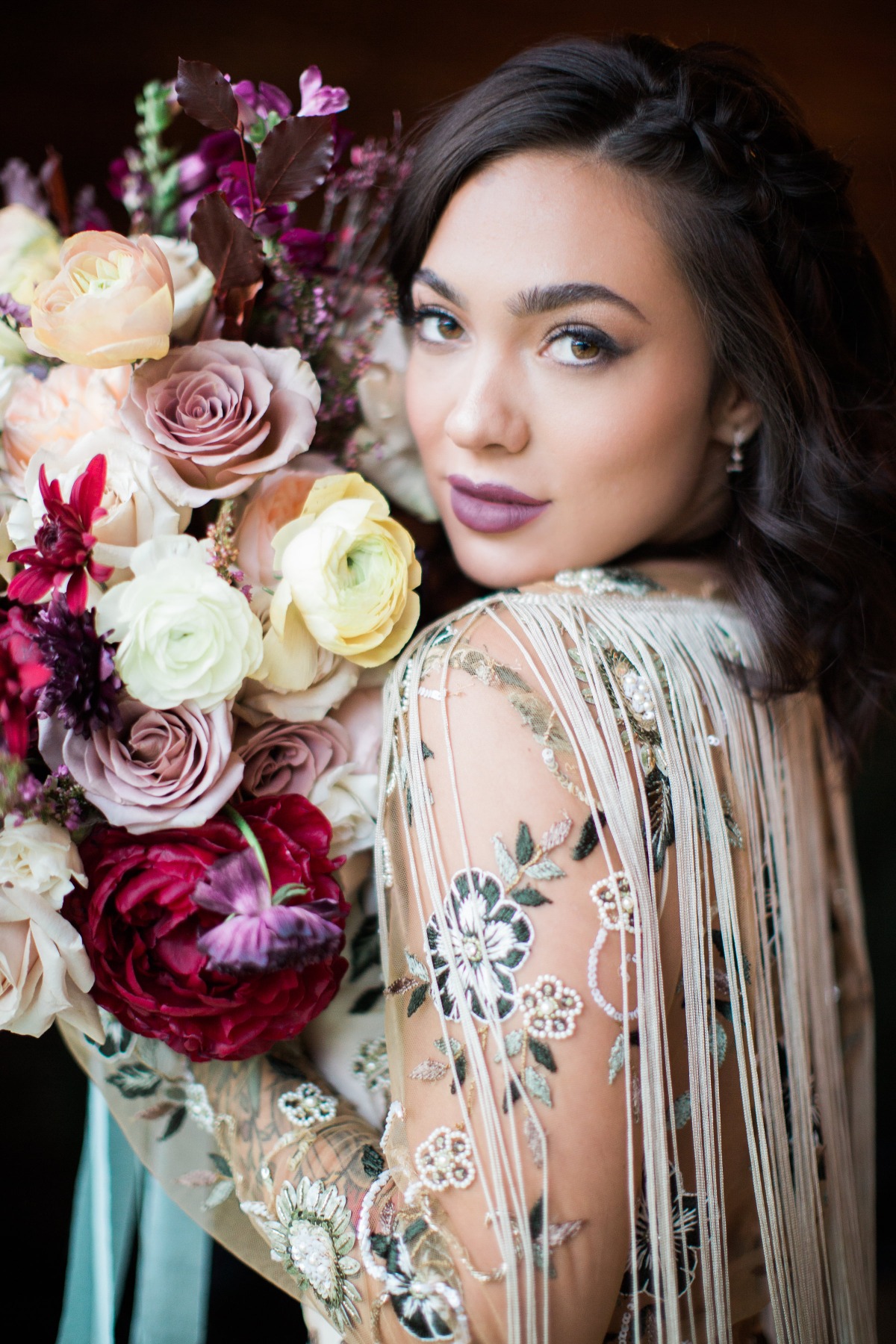 Beautiful woman with bouquet and floral embroidered dress