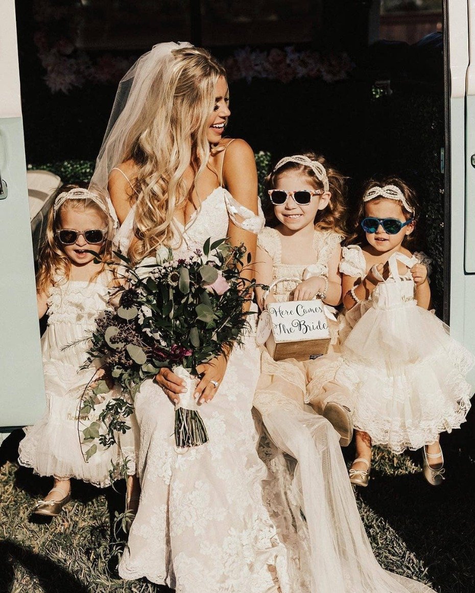 Bride with sunglass wearing flower girls
