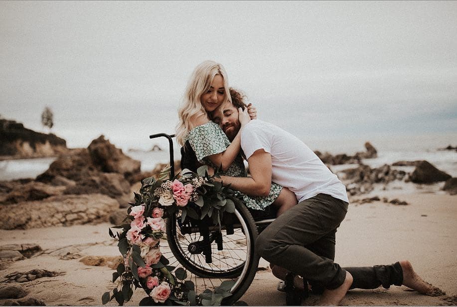 Engagement photos and hugs between a bride in a wheelchair and her groom