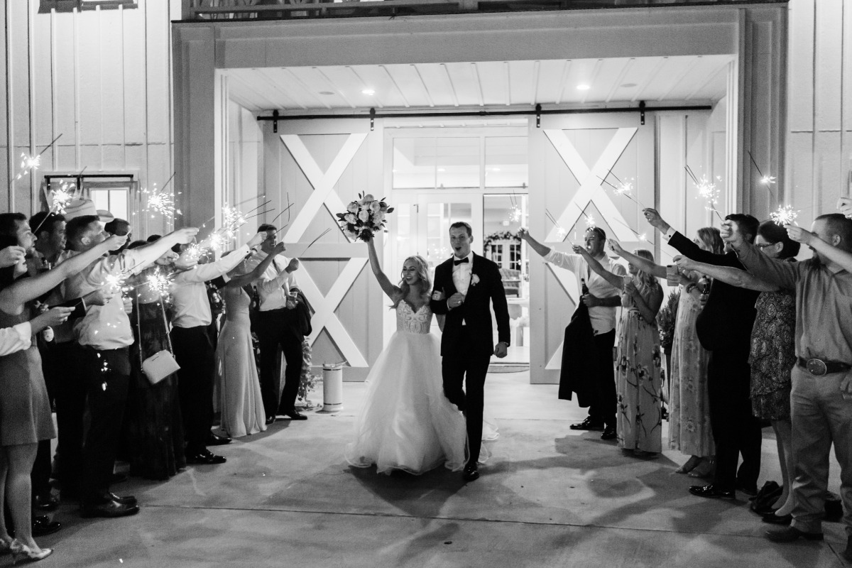 Newlyweds exit under sparklers at their wedding celebration