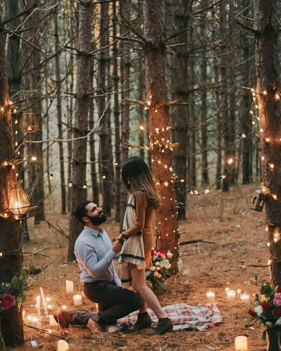 A proposal in the woods twinkling lights