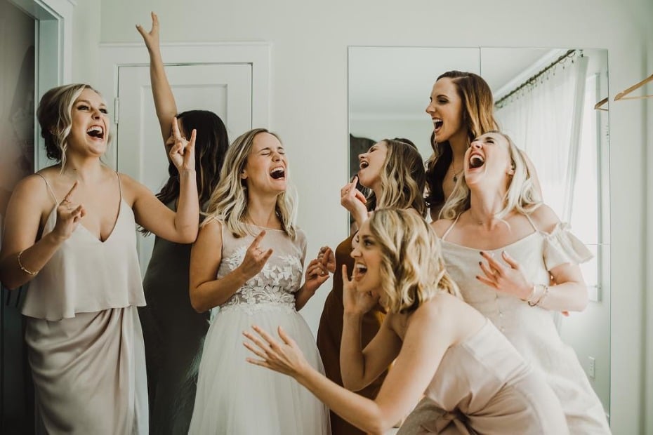 Bride singing out loud with her bridesmaids