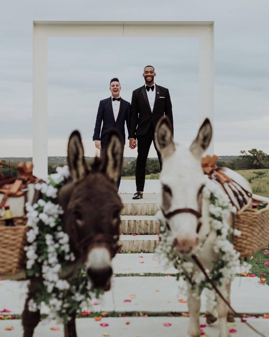Grooms just married with beer burros