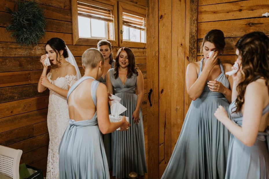 Bride and her bridesmaids crying over the big day