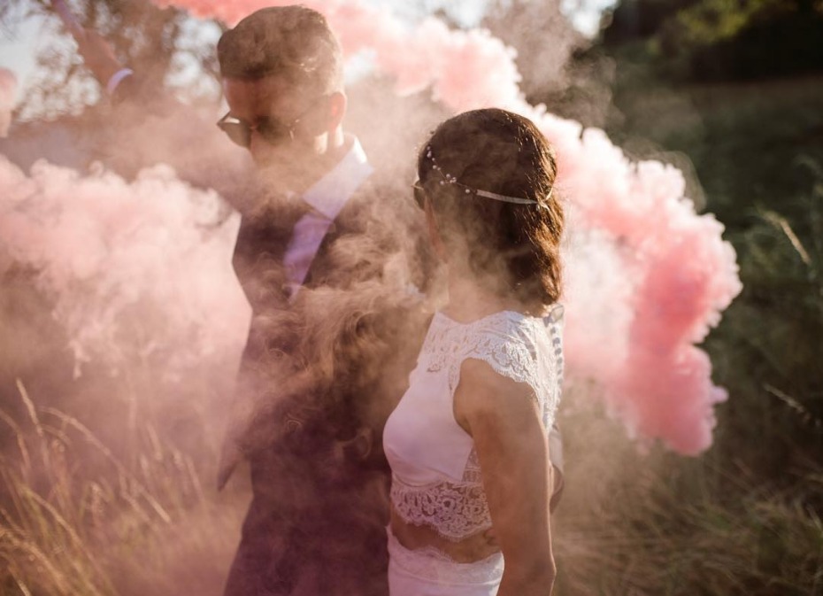 Pink smoke bomb photography with bride and groom