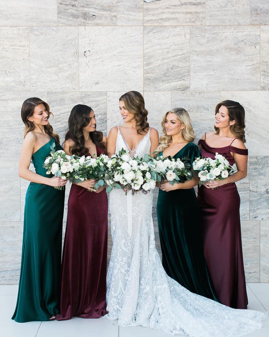 Bride and bridesmaids in jewel tone and velvet dresses
