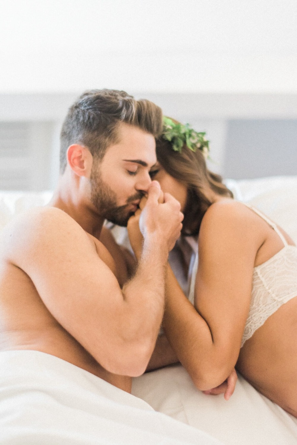 Romantic couple embracing intimately in bed