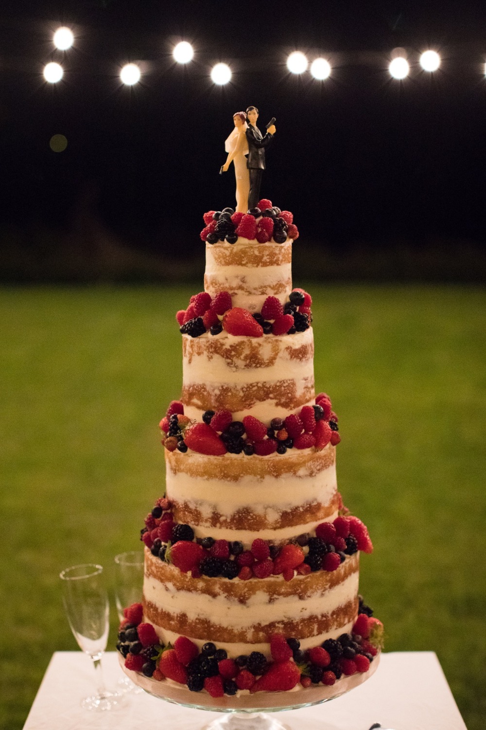 berry topped wedding cake with James Bond topper