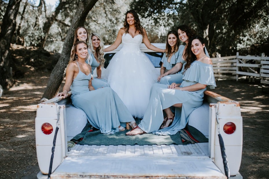 bride and her bridesmaids hitching a ride to the wedding