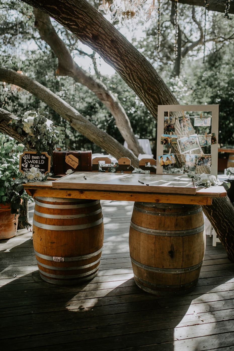 Wedding reception guest book table with barrel legs outdoors